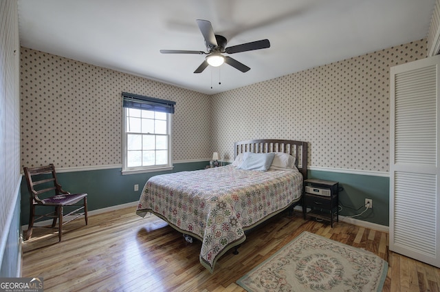 bedroom with ceiling fan and wood-type flooring