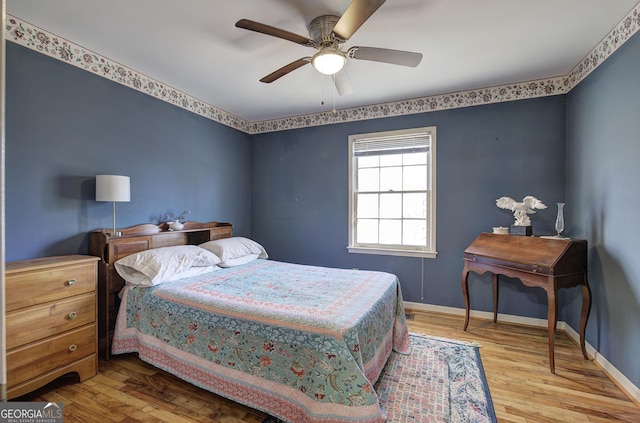 bedroom with ceiling fan and light hardwood / wood-style flooring