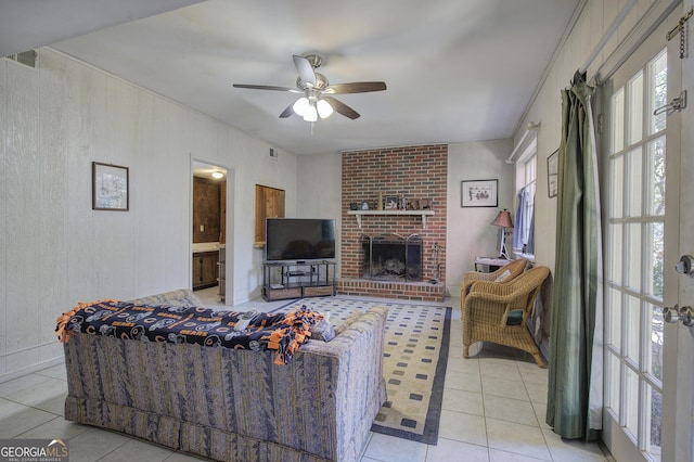 tiled living room with ceiling fan and a brick fireplace