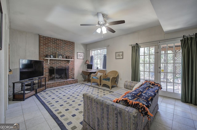 tiled living room featuring ceiling fan, french doors, and a fireplace