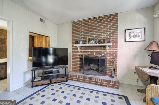 living room with light tile patterned floors and a fireplace