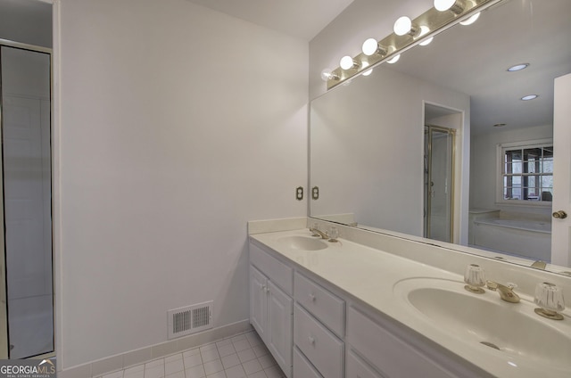bathroom with a sink, visible vents, tile patterned flooring, and a shower stall