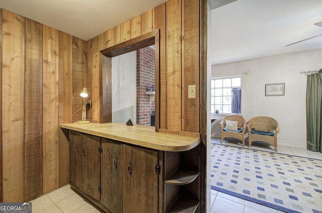 bar featuring wood walls and light tile patterned flooring