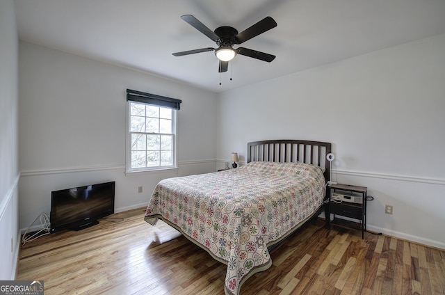bedroom featuring hardwood / wood-style floors, baseboards, and ceiling fan