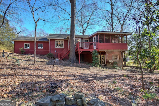 back of house featuring a deck and a sunroom