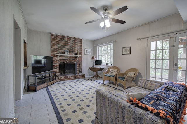 tiled living area with a fireplace and ceiling fan