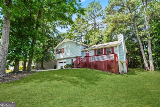 view of front of home with a garage, a front lawn, and a wooden deck