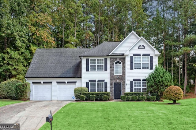 colonial-style house featuring a garage and a front lawn