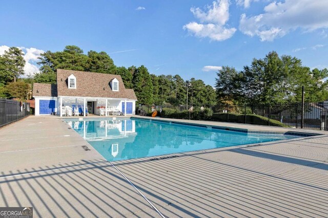 view of pool with a patio area and an outdoor structure