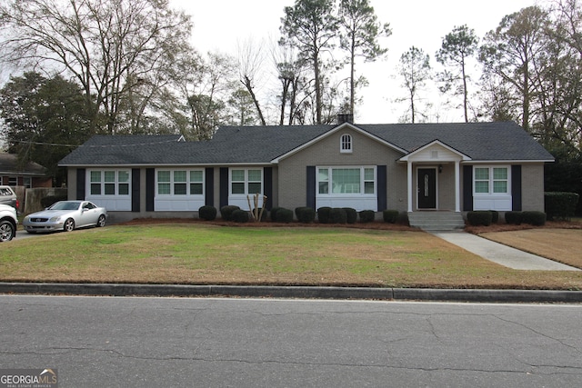 single story home featuring a front yard