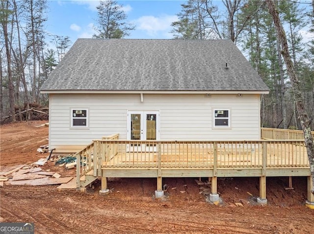 back of house with a wooden deck and french doors