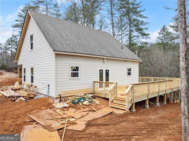 back of house featuring a wooden deck and french doors