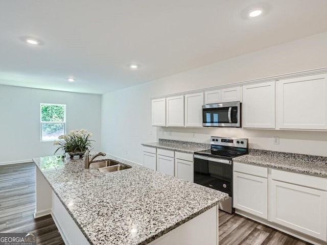 kitchen with sink, white cabinets, and stainless steel appliances