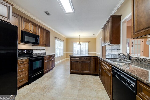 kitchen with kitchen peninsula, sink, black appliances, pendant lighting, and a chandelier