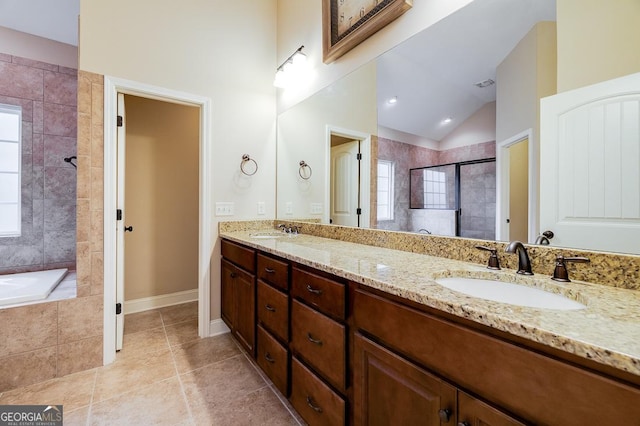 bathroom featuring tile patterned floors, vanity, independent shower and bath, and vaulted ceiling