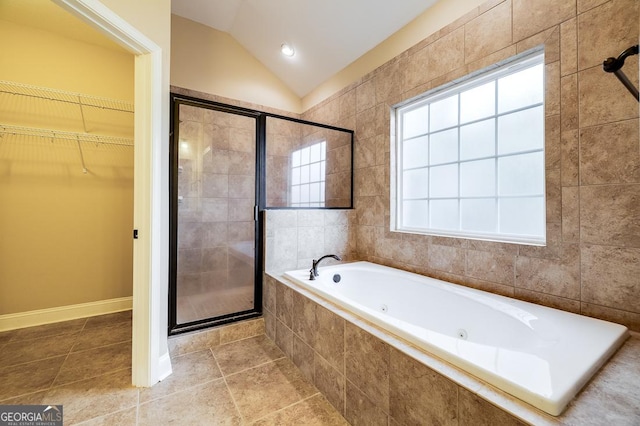 bathroom with separate shower and tub, tile patterned floors, plenty of natural light, and lofted ceiling