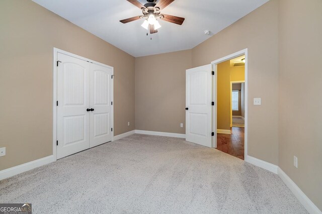 unfurnished bedroom featuring carpet flooring, a closet, and ceiling fan