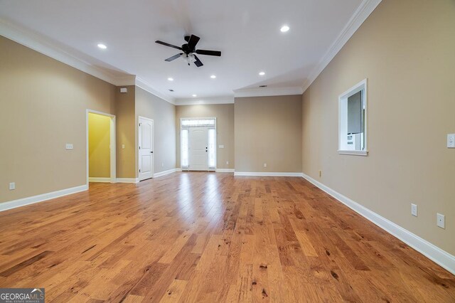 unfurnished living room featuring ceiling fan, light hardwood / wood-style flooring, and ornamental molding