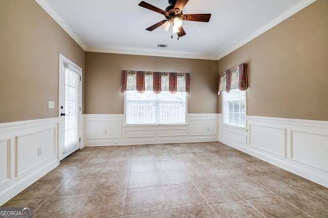 tiled spare room with ceiling fan and ornamental molding