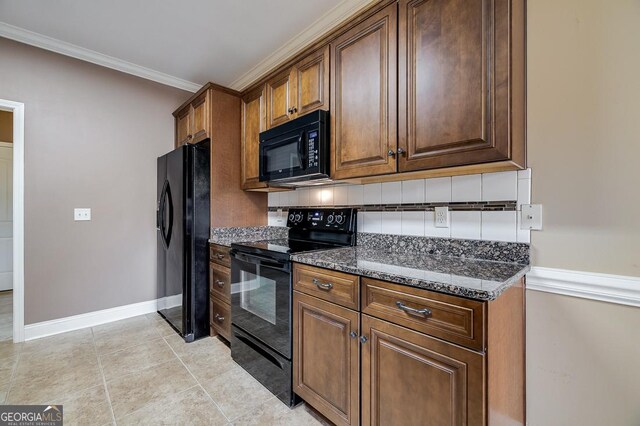 kitchen with black appliances, dark stone countertops, ornamental molding, light tile patterned floors, and tasteful backsplash