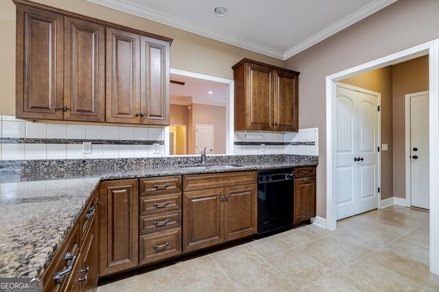 kitchen with tasteful backsplash, crown molding, sink, dark stone countertops, and black dishwasher