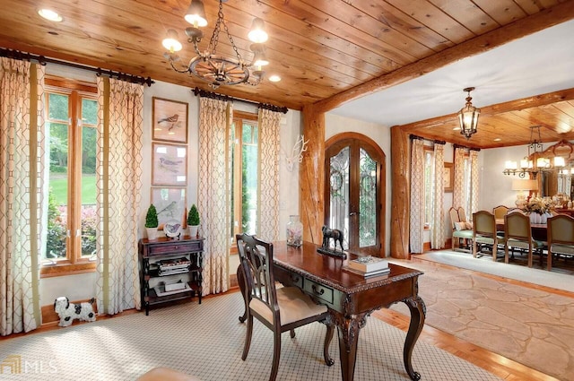 dining space with a chandelier, french doors, and plenty of natural light