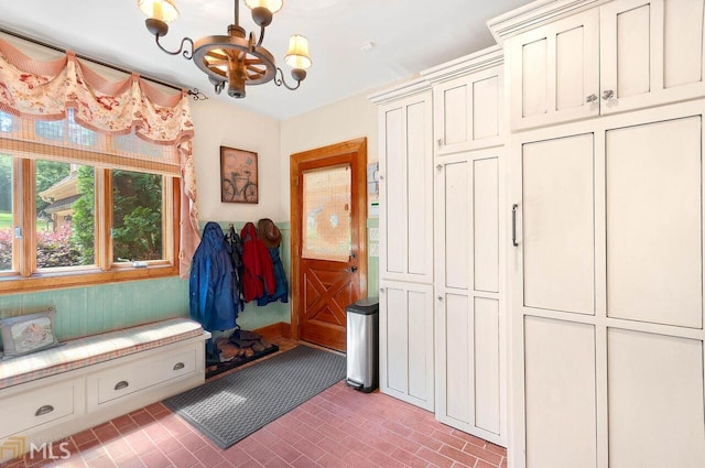 mudroom with a chandelier