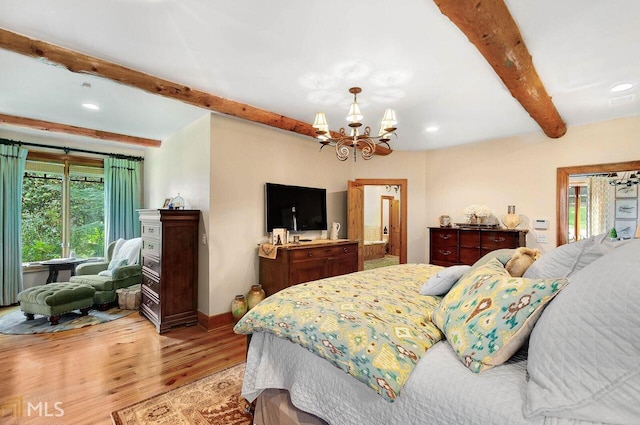 bedroom featuring beamed ceiling, light wood-type flooring, and an inviting chandelier