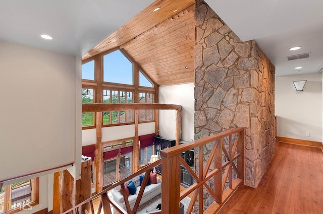 hallway with hardwood / wood-style floors, wooden ceiling, and vaulted ceiling