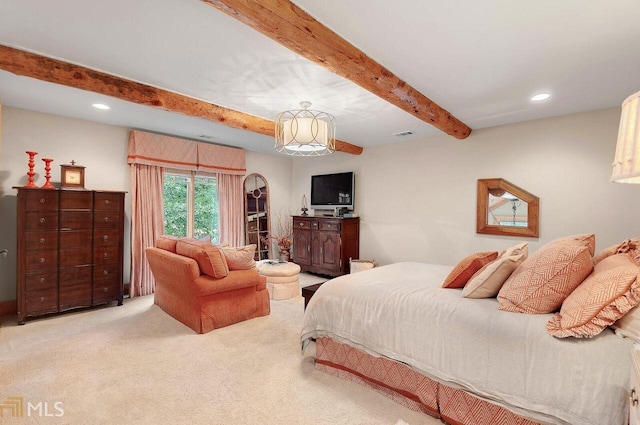 carpeted bedroom with beamed ceiling