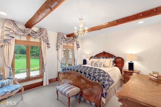 bedroom featuring carpet floors and an inviting chandelier