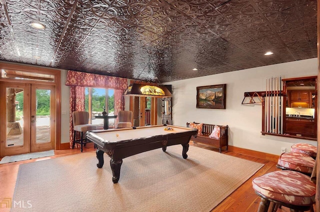 playroom featuring hardwood / wood-style flooring, pool table, and french doors