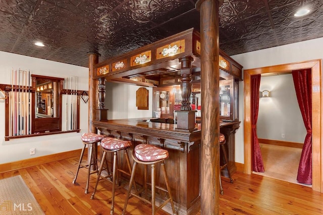 bar with light hardwood / wood-style floors