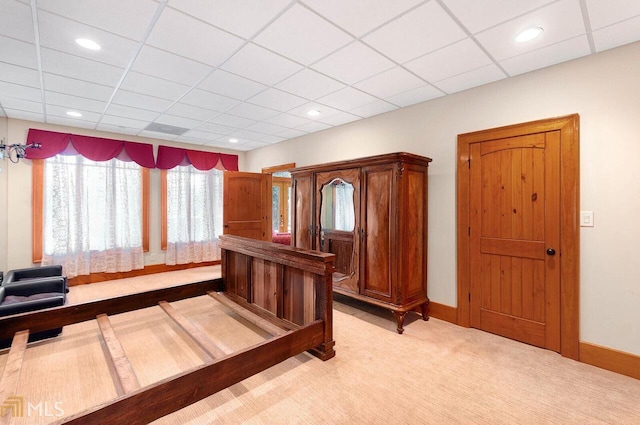 bedroom featuring a paneled ceiling and carpet floors