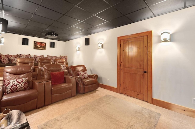 cinema room with carpet flooring and a paneled ceiling