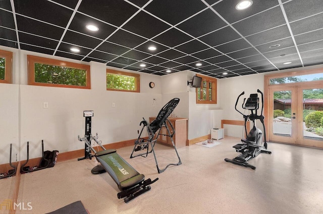 workout room featuring a paneled ceiling and french doors