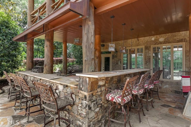 view of patio with an outdoor bar