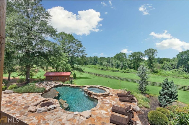 view of pool with a lawn, a rural view, and an in ground hot tub