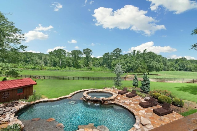 view of pool with a lawn, a rural view, and an in ground hot tub