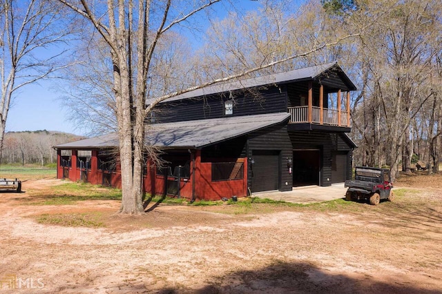 view of front of home with a garage and a balcony