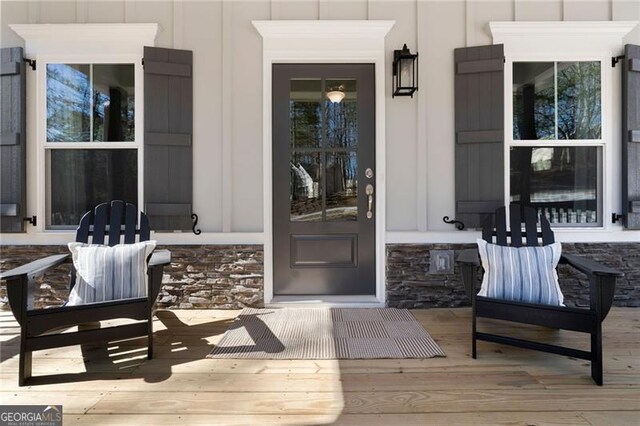 entrance to property featuring stone siding