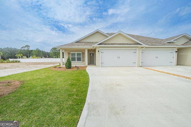 view of front of house featuring a garage and a front lawn