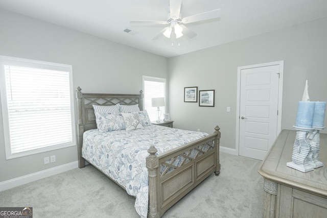 bedroom featuring light colored carpet and ceiling fan