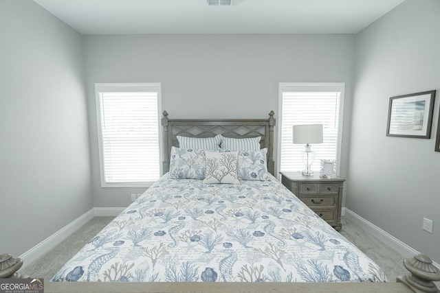 carpeted bedroom with multiple windows