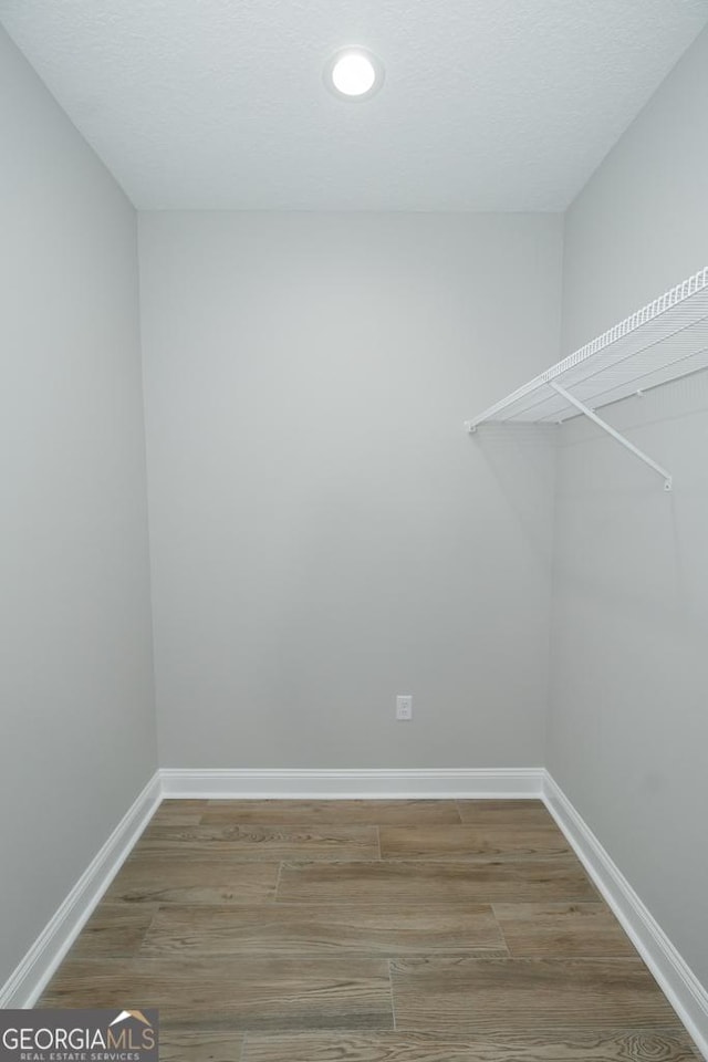 walk in closet featuring hardwood / wood-style flooring