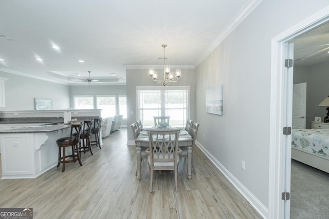 dining space featuring crown molding, ceiling fan with notable chandelier, and light wood-type flooring