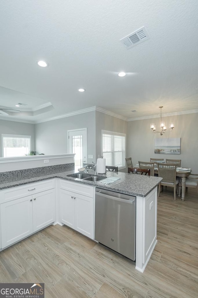 kitchen with pendant lighting, dishwasher, sink, light wood-type flooring, and white cabinetry