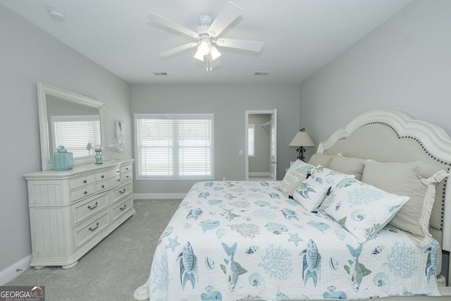 bedroom with light carpet and ceiling fan