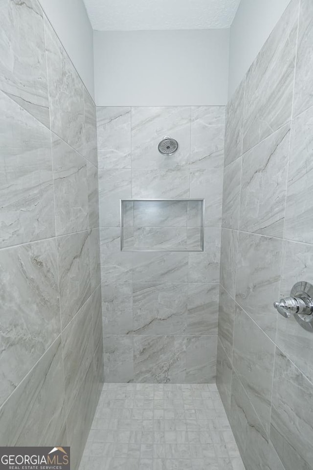 bathroom with a tile shower