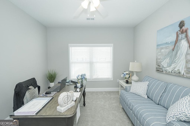 carpeted home office featuring ceiling fan